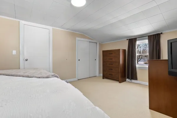 a bedroom with a bed and cabinets