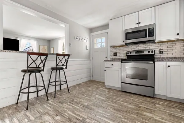 a kitchen with stainless steel appliances a stove a sink and a microwave