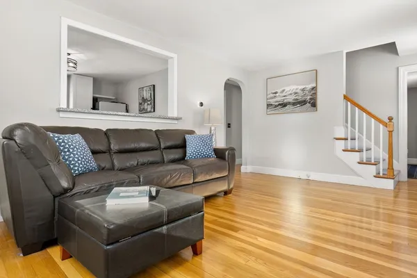 a living room with furniture and a wooden floor