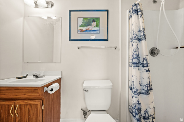 1650 Nichole Circle Sandy, UT 84093 - Photo 25 of 31 Bathroom vanity with a white countertop and wood-finish cabinetry
