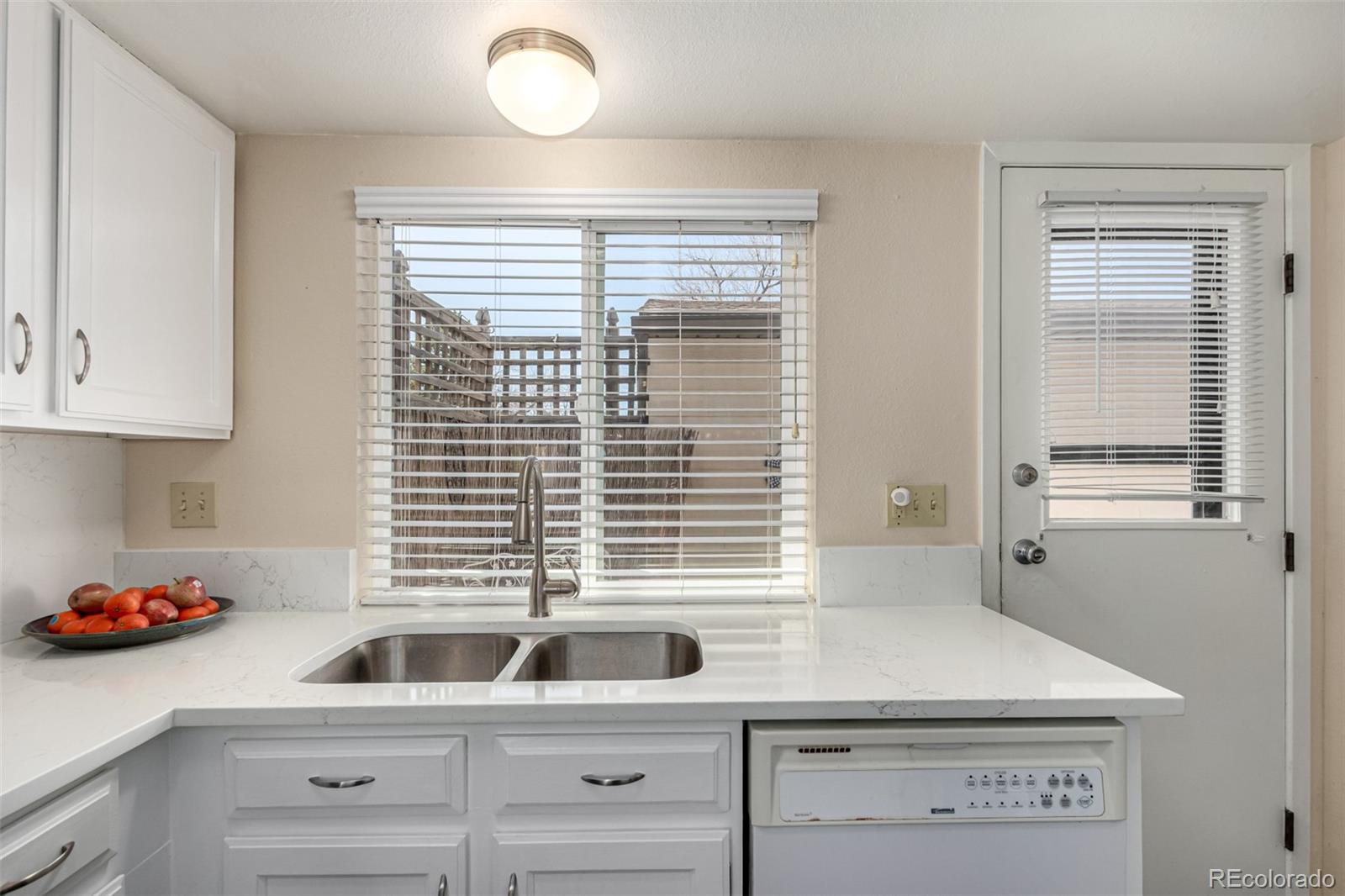 3657 South Laredo Street, Unit E Aurora, CO 80013 - Photo 5 of 20 a kitchen with windows and chandelier
