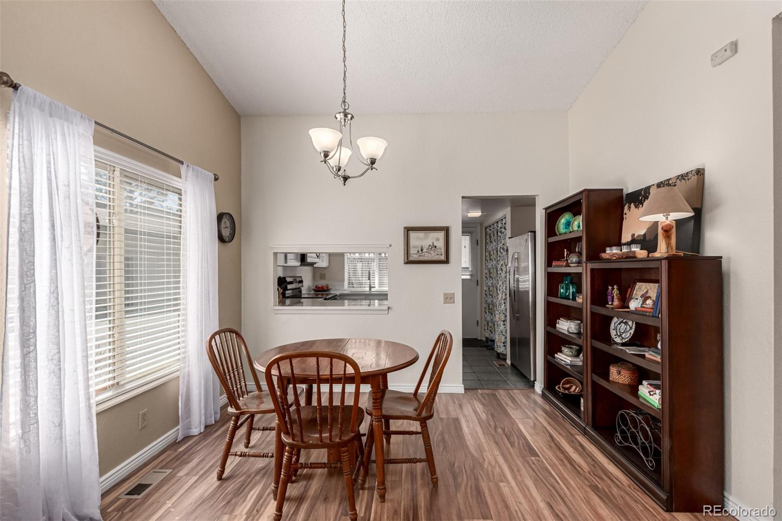 3657 South Laredo Street, Unit E Aurora, CO 80013 - Photo 8 of 20 a view of a dining room with furniture and wooden floor