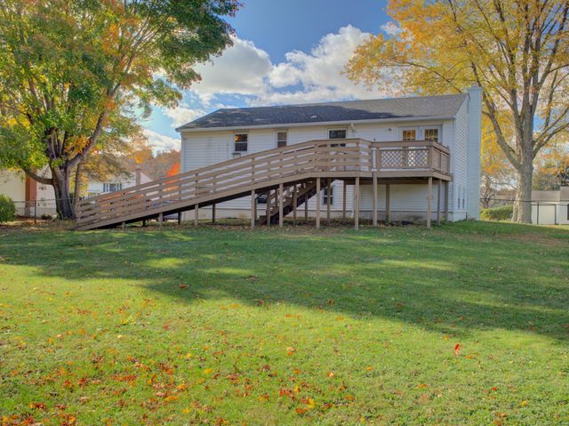 a large kitchen with cabinets and wooden floor