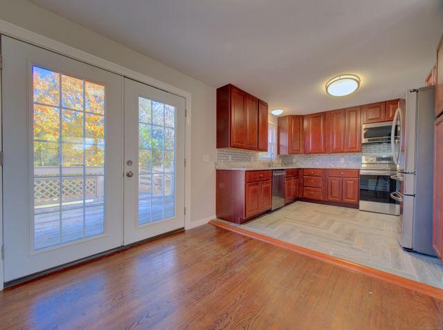 a kitchen with granite countertop a stove top oven sink and cabinets
