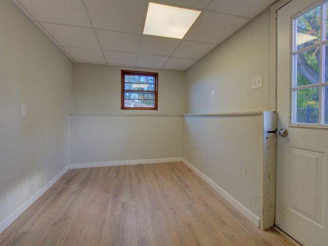 an empty room with stairs and windows