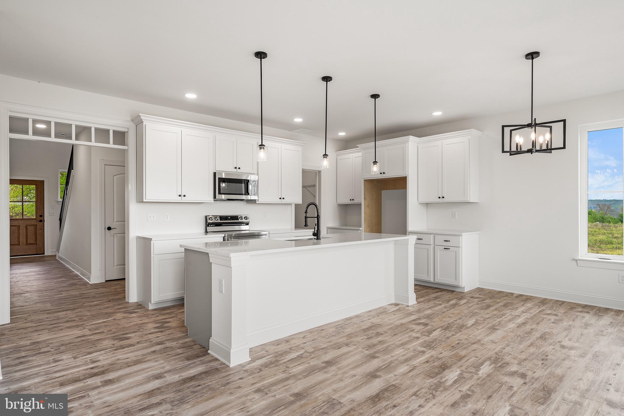 27 Lausch Road Denver, PA 17517 - Photo 20 of 43 a kitchen with stainless steel appliances granite countertop a refrigerator a stove a sink dishwasher and a wooden cabinets with wooden floor