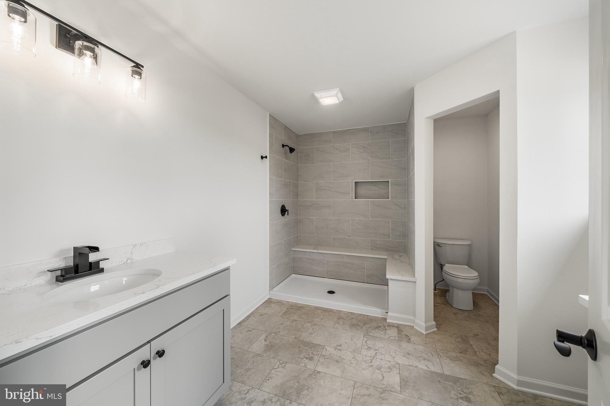 27 Lausch Road Denver, PA 17517 - Photo 27 of 43 a bathroom with a granite countertop sink a toilet and shower