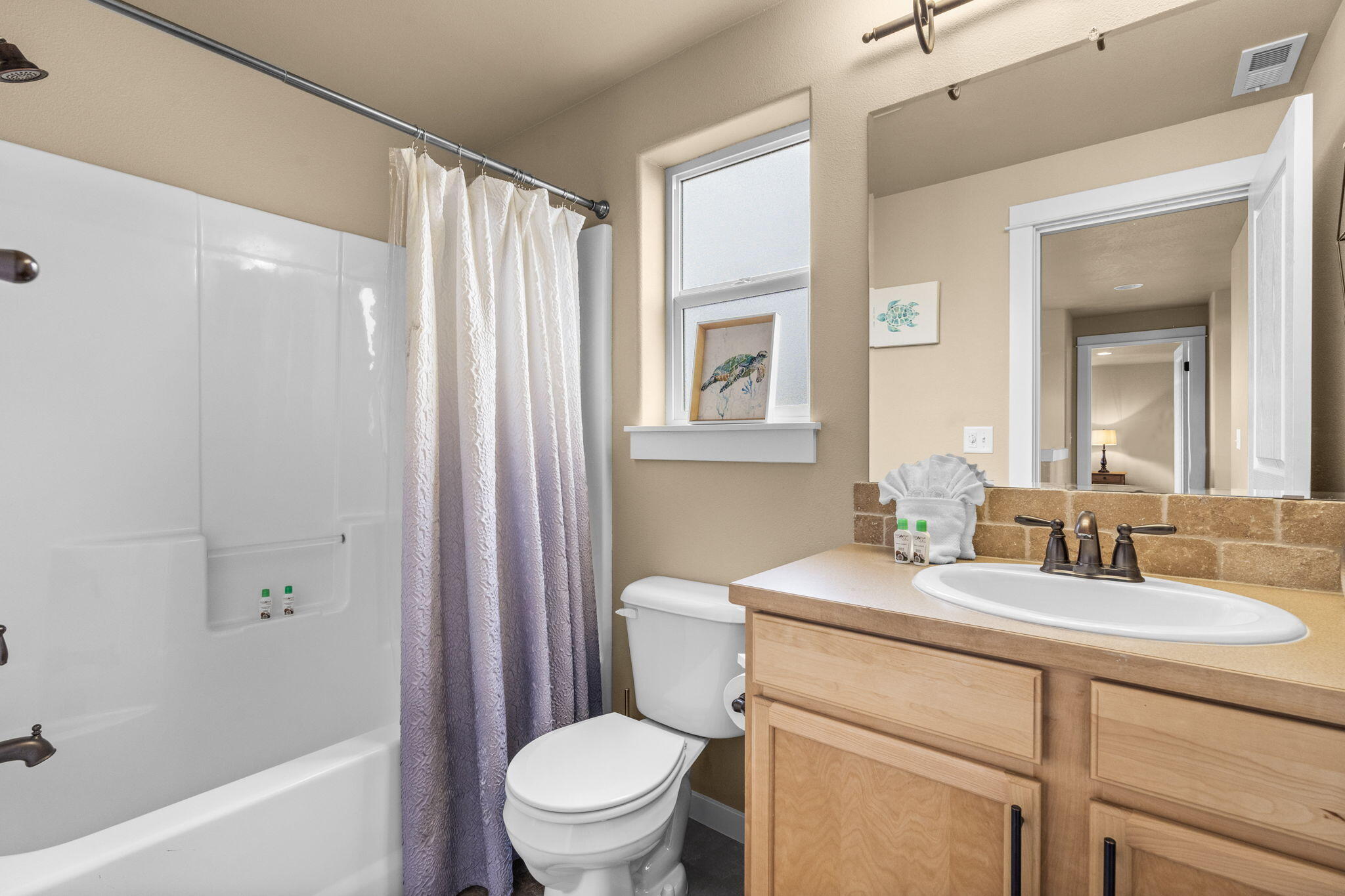 2781 Northeast Spring Water Place Bend, OR 97701 - Photo 13 of 23 a bathroom with a toilet a sink a mirror a bathtub and shower