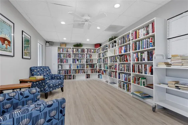 a living room with lots of furniture and book shelf