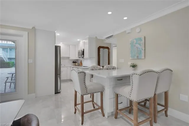 a view of a dining room with furniture and a chandelier