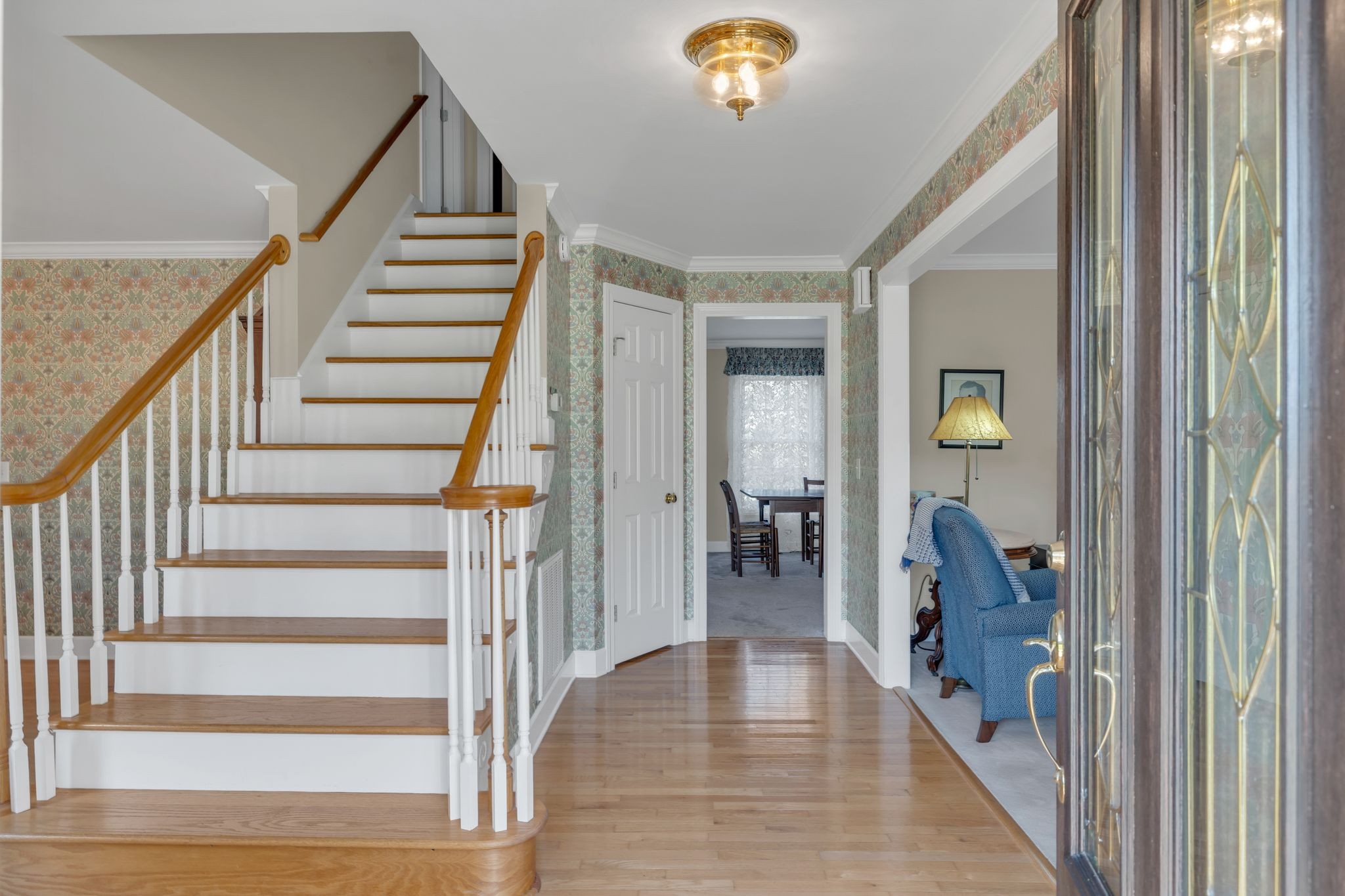 207 Sugar Tree Lane Pulaski, TN 38478 - Photo 13 of 30 a view of a hallway to a livingroom with wooden floor and stairs