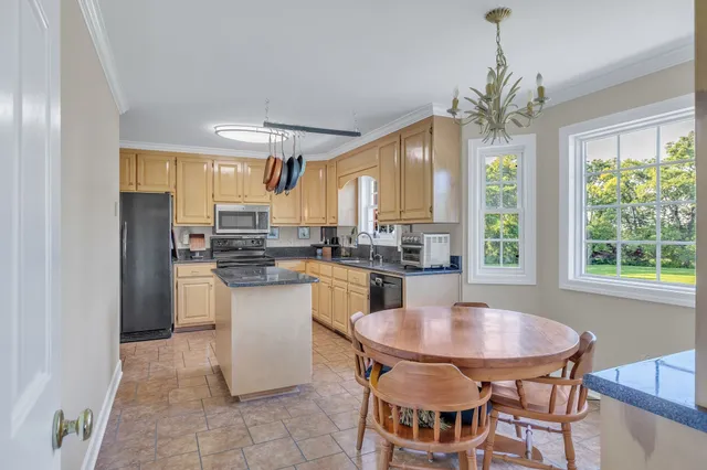 a kitchen with a table and chairs in it