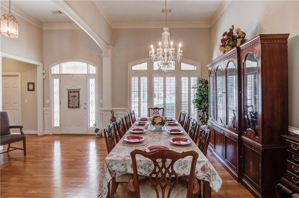 8012 Cypress Point Monroe, GA 30656 - Photo 13 of 67 a view of a dining room with furniture wooden floor and chandelier