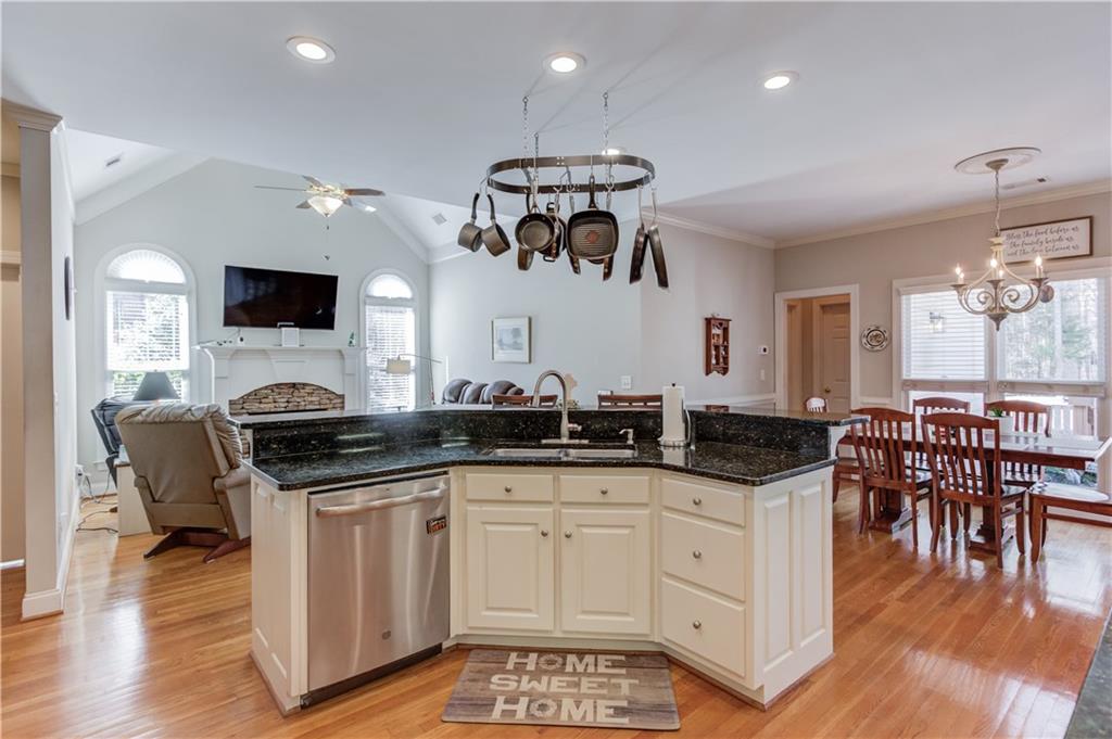 8012 Cypress Point Monroe, GA 30656 - Photo 19 of 67 a very nice looking kitchen with granite countertop a stove and a wooden floors