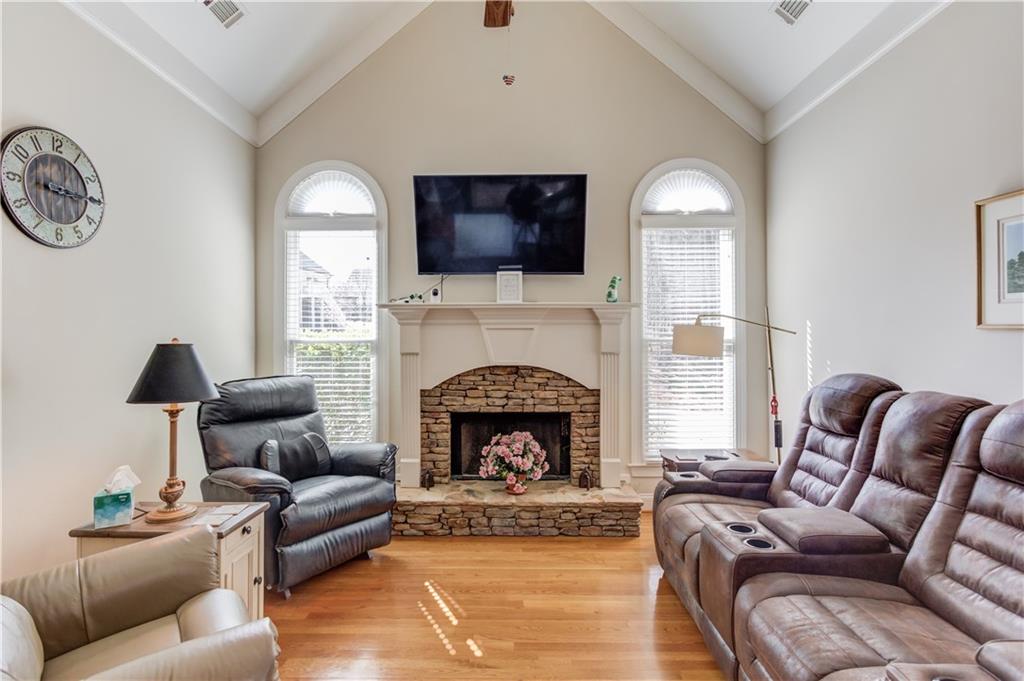 8012 Cypress Point Monroe, GA 30656 - Photo 21 of 67 a living room with furniture a flat screen tv and a fireplace
