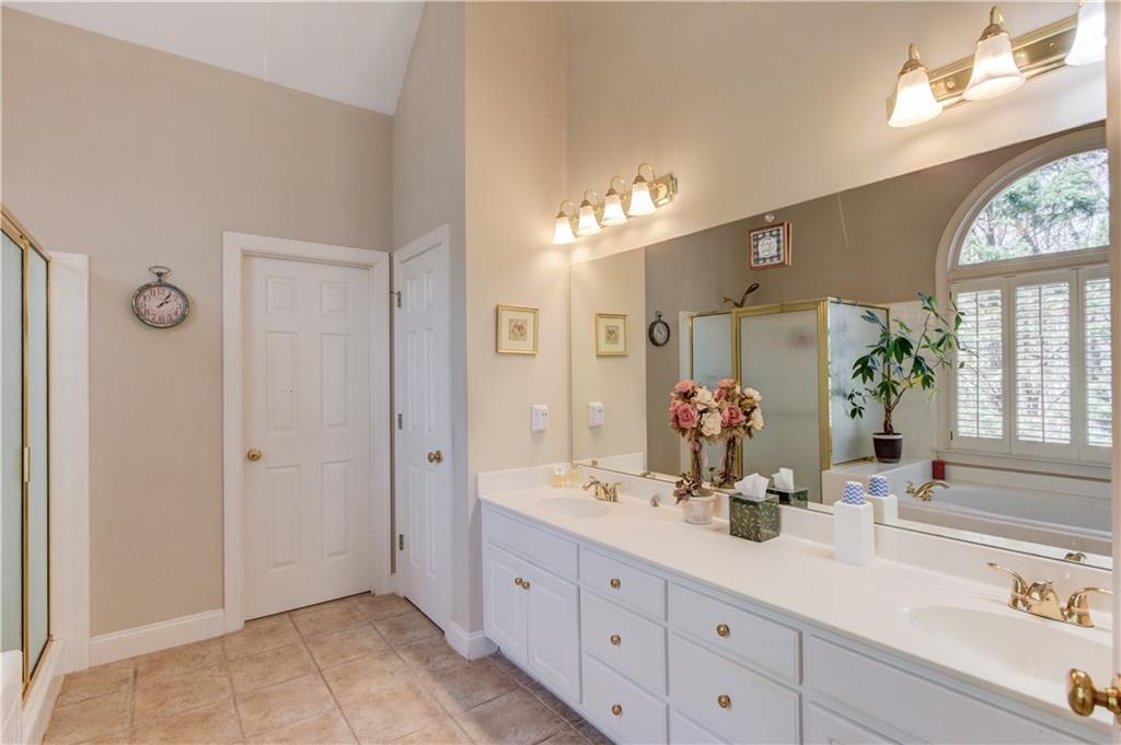 8012 Cypress Point Monroe, GA 30656 - Photo 28 of 67 a bathroom with a double vanity sink and a mirror