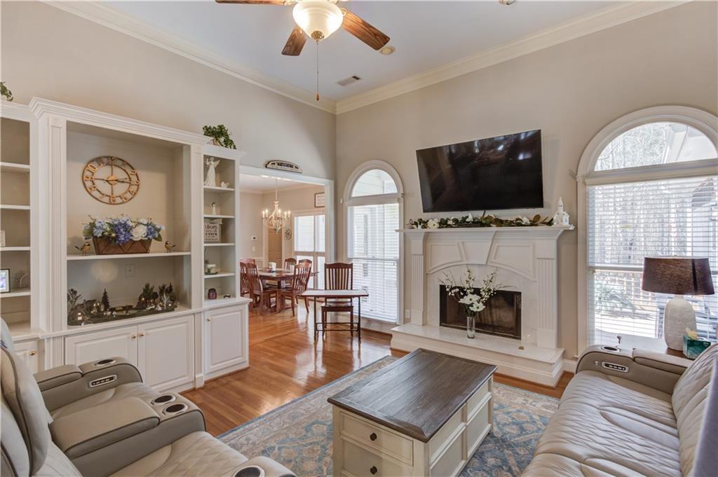 8012 Cypress Point Monroe, GA 30656 - Photo 3 of 67 a living room with furniture a fireplace and a flat screen tv