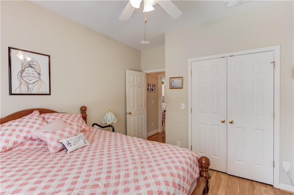 8012 Cypress Point Monroe, GA 30656 - Photo 34 of 67 a bedroom with a large bed and a chandelier