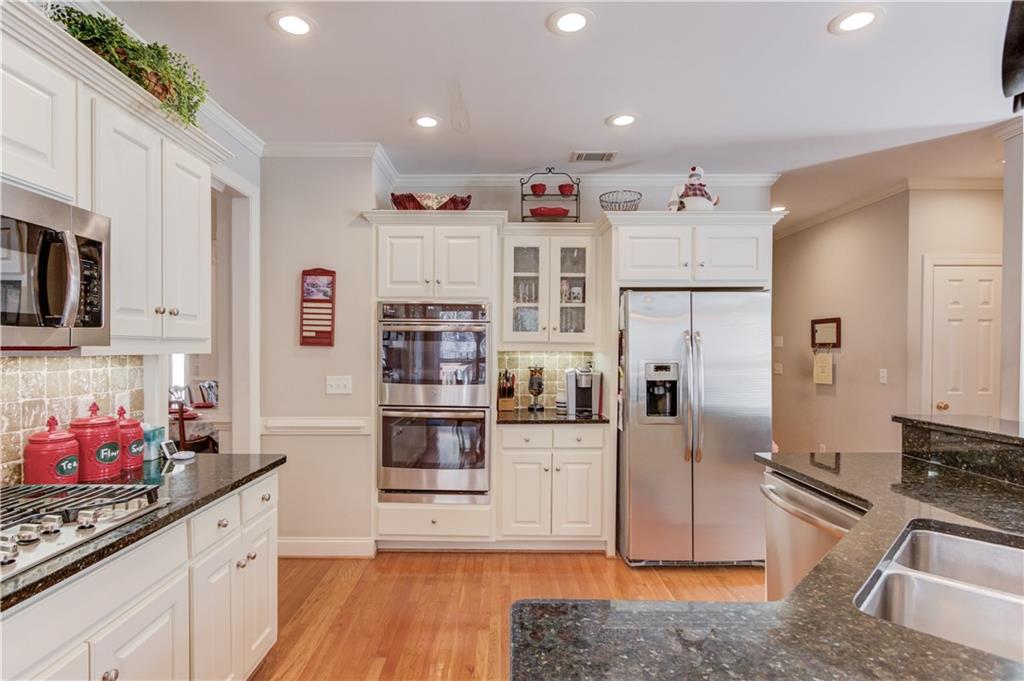 8012 Cypress Point Monroe, GA 30656 - Photo 4 of 67 a kitchen with stainless steel appliances kitchen island granite countertop a refrigerator and stove