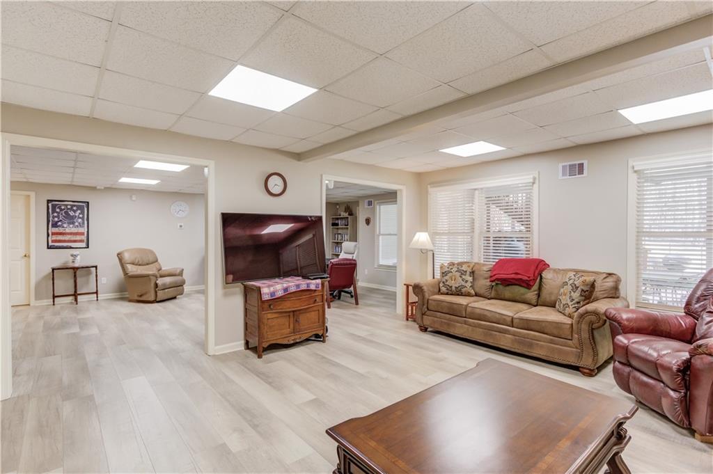 8012 Cypress Point Monroe, GA 30656 - Photo 43 of 67 a living room with furniture and a flat screen tv