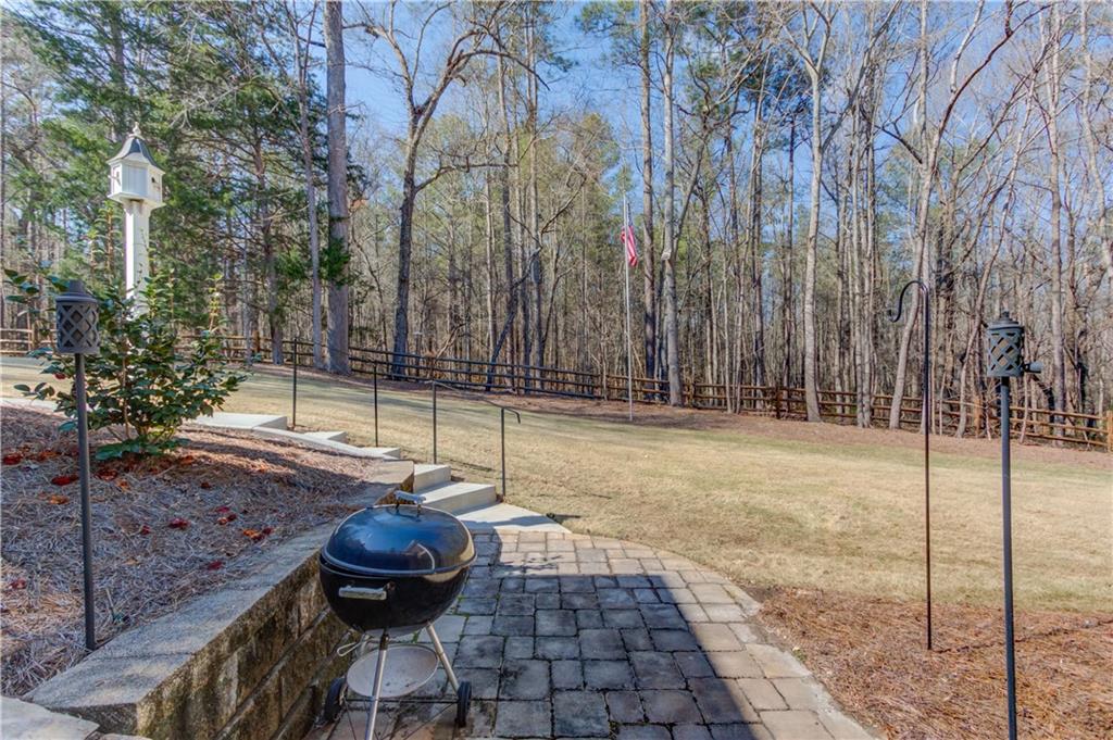 8012 Cypress Point Monroe, GA 30656 - Photo 54 of 67 a backyard of a house with table and chairs