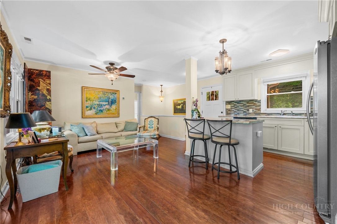 467 Horseshoe Ridge Road East Deep Gap, NC 28618 - Photo 13 of 46 a view of a dining room with furniture wooden floor and a chandelier