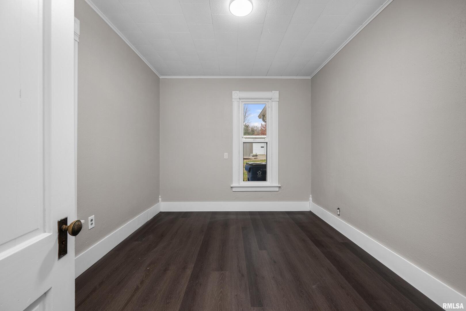 405 North Bluff Street Albany, IL 61230 - Photo 13 of 31 a view of an empty room with wooden floor and a window