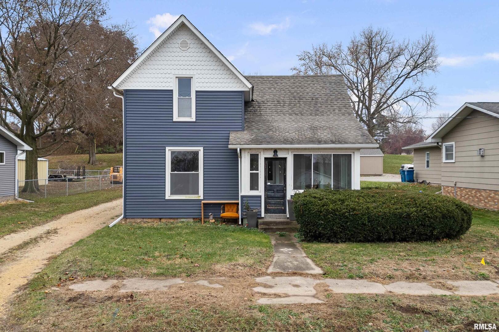 405 North Bluff Street Albany, IL 61230 - Photo 2 of 31 a front view of a house with garden