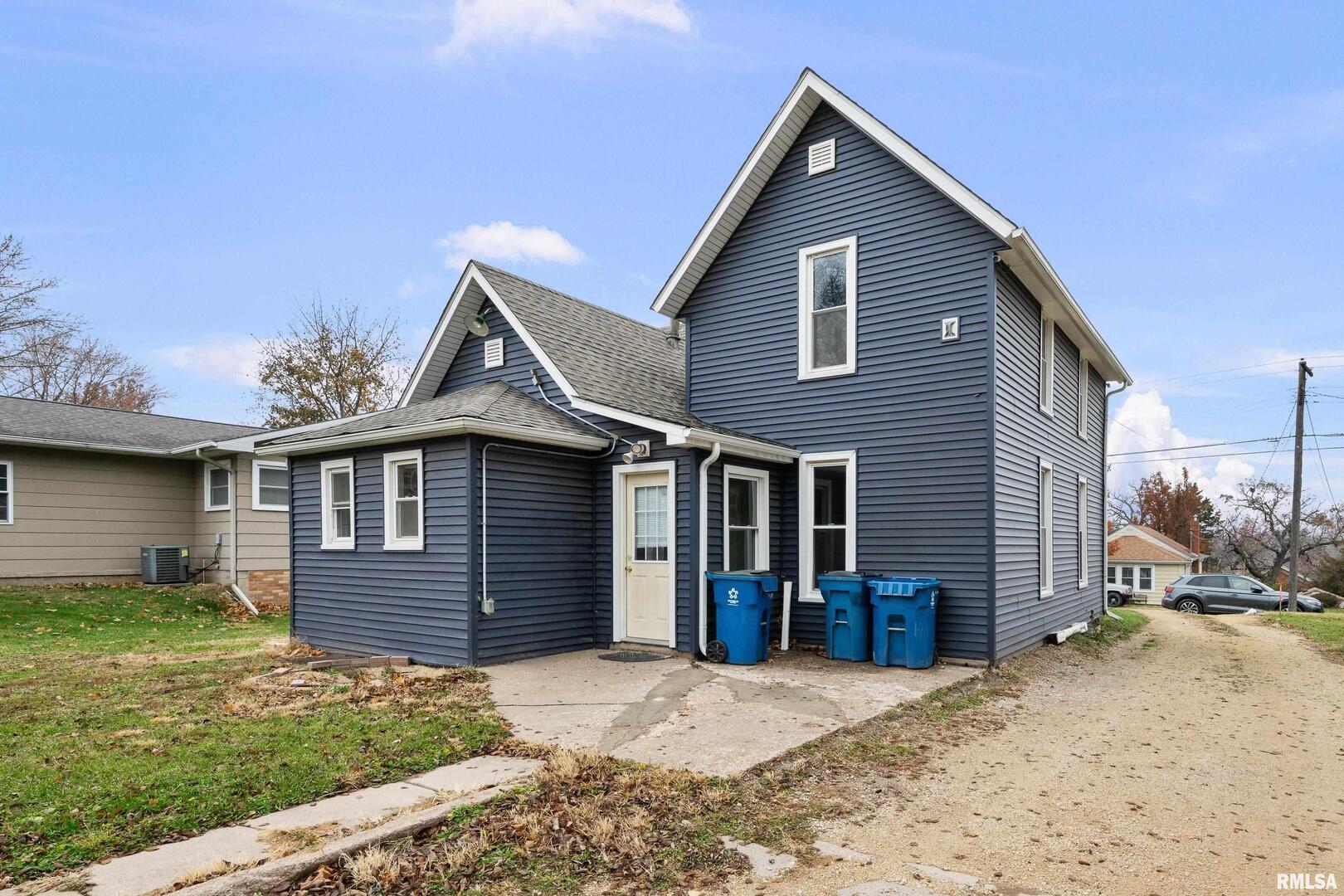 405 North Bluff Street Albany, IL 61230 - Photo 27 of 31 a front view of a house with a yard and garage