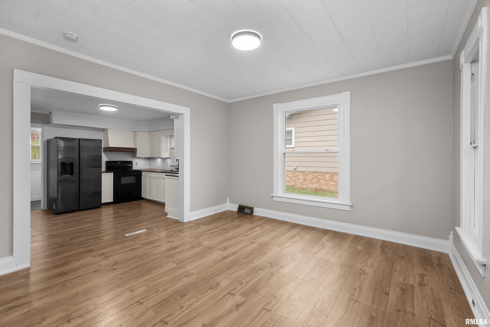 405 North Bluff Street Albany, IL 61230 - Photo 8 of 31 an empty room with wooden floor and windows