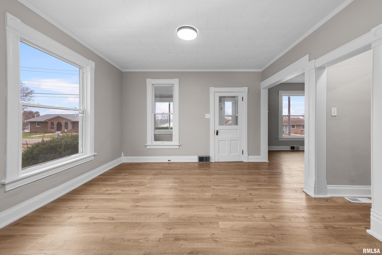 405 North Bluff Street Albany, IL 61230 - Photo 9 of 31 a view of an empty room with window and wooden floor