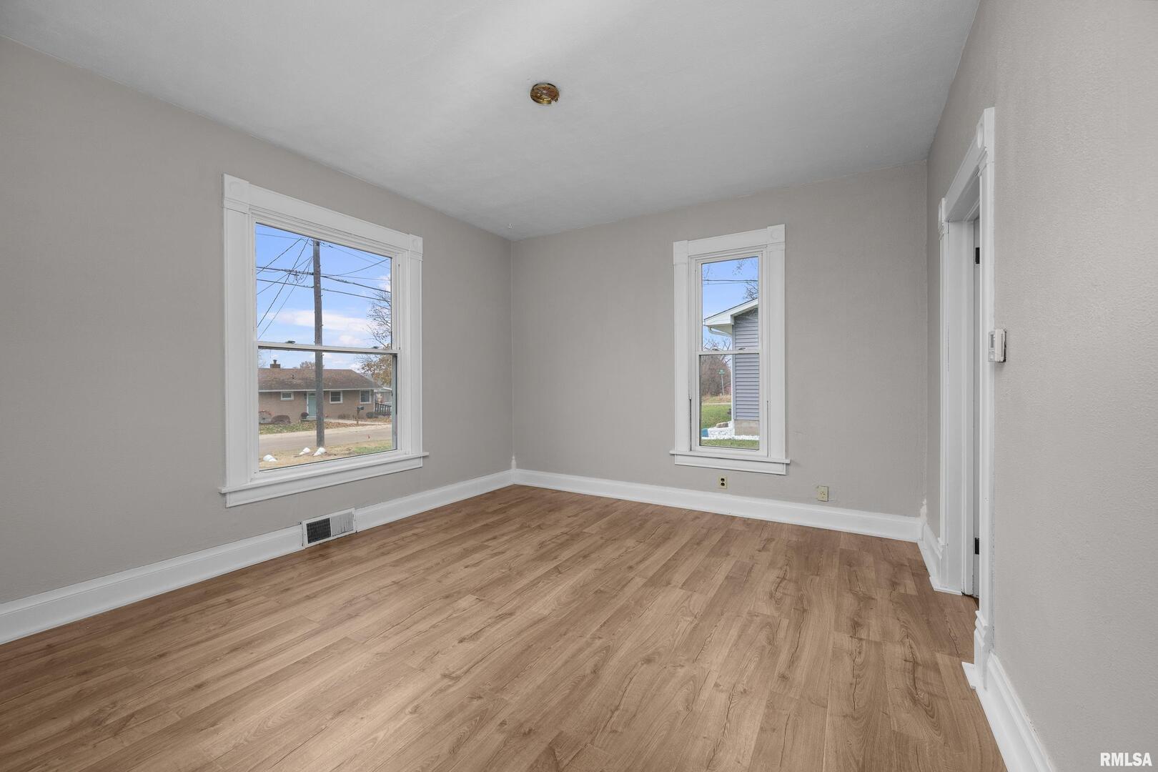 405 North Bluff Street Albany, IL 61230 - Photo 10 of 31 a view of an empty room with wooden floor and a window