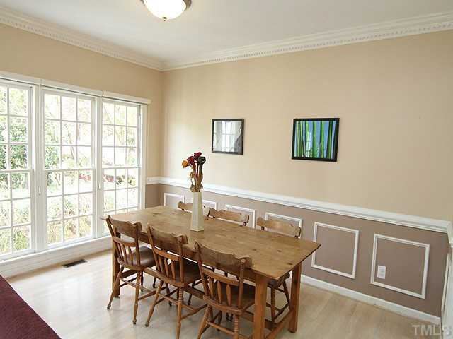 5101 Talton Circle Raleigh, NC 27612 - Photo 5 of 25 Large formal dining room perfect for entertaining fills with natural light. Chair rail, crown molding, and wood floors. Dining Room