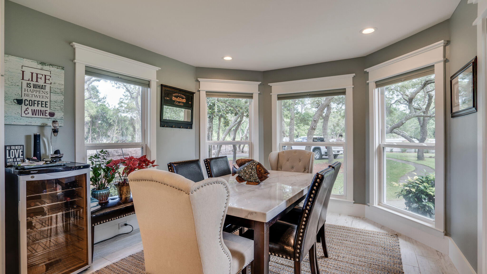 786 Mack Bayou Road Santa Rosa Beach, FL 32459 - Photo 15 of 42 a view of a dining room with furniture large windows and wooden floor