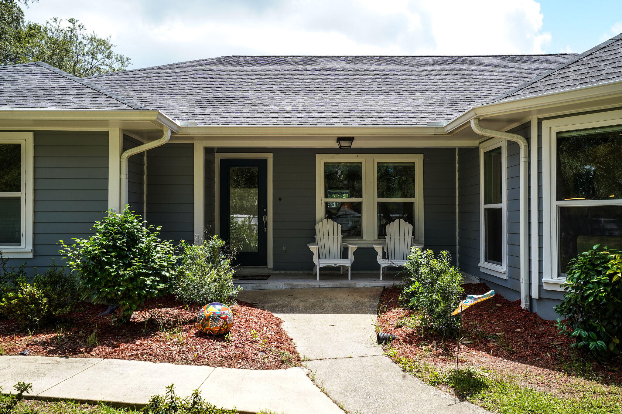 786 Mack Bayou Road Santa Rosa Beach, FL 32459 - Photo 2 of 42 a front view of a house with garden