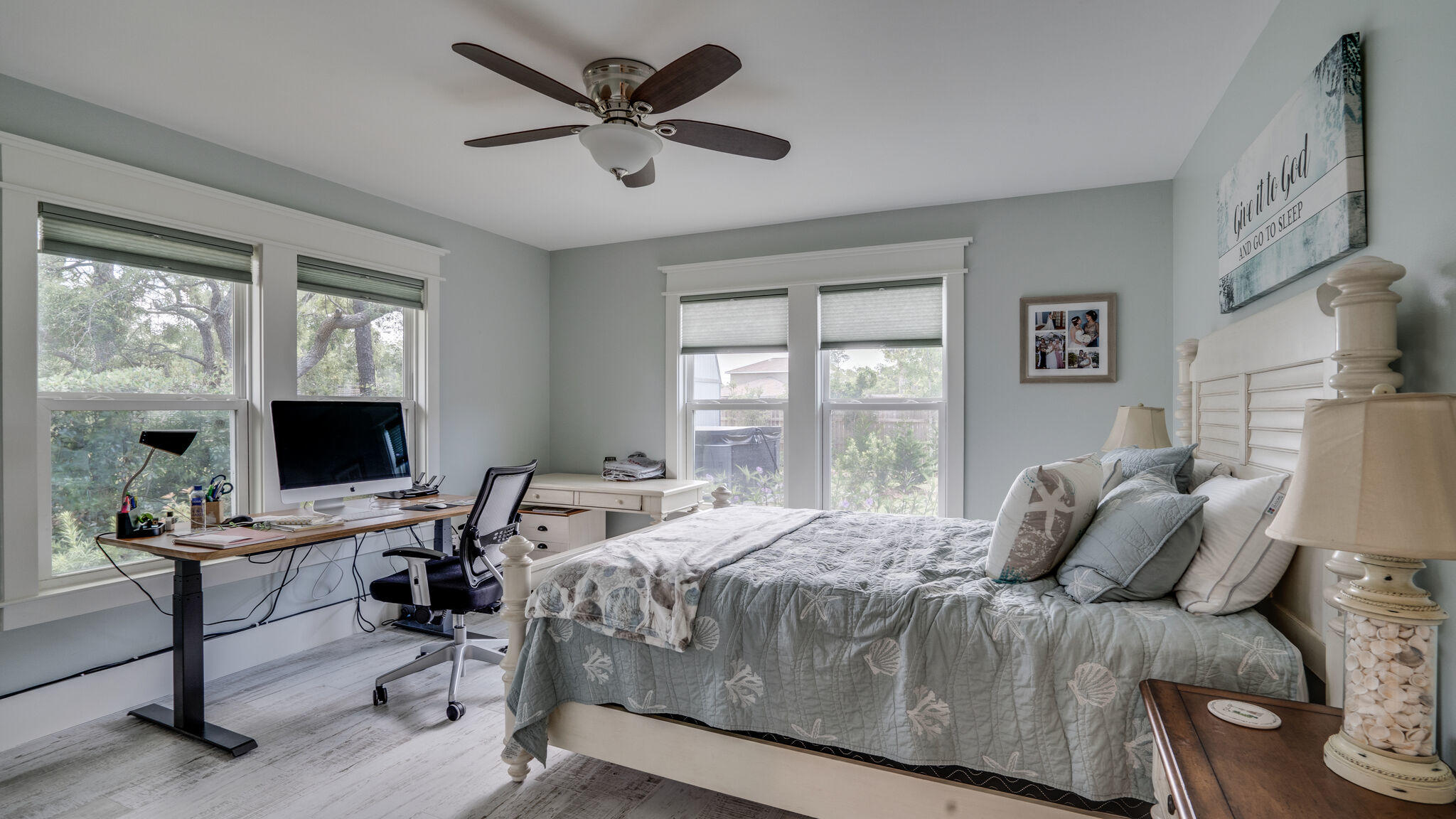 786 Mack Bayou Road Santa Rosa Beach, FL 32459 - Photo 27 of 42 a bedroom with a bed a large window and a flat screen tv