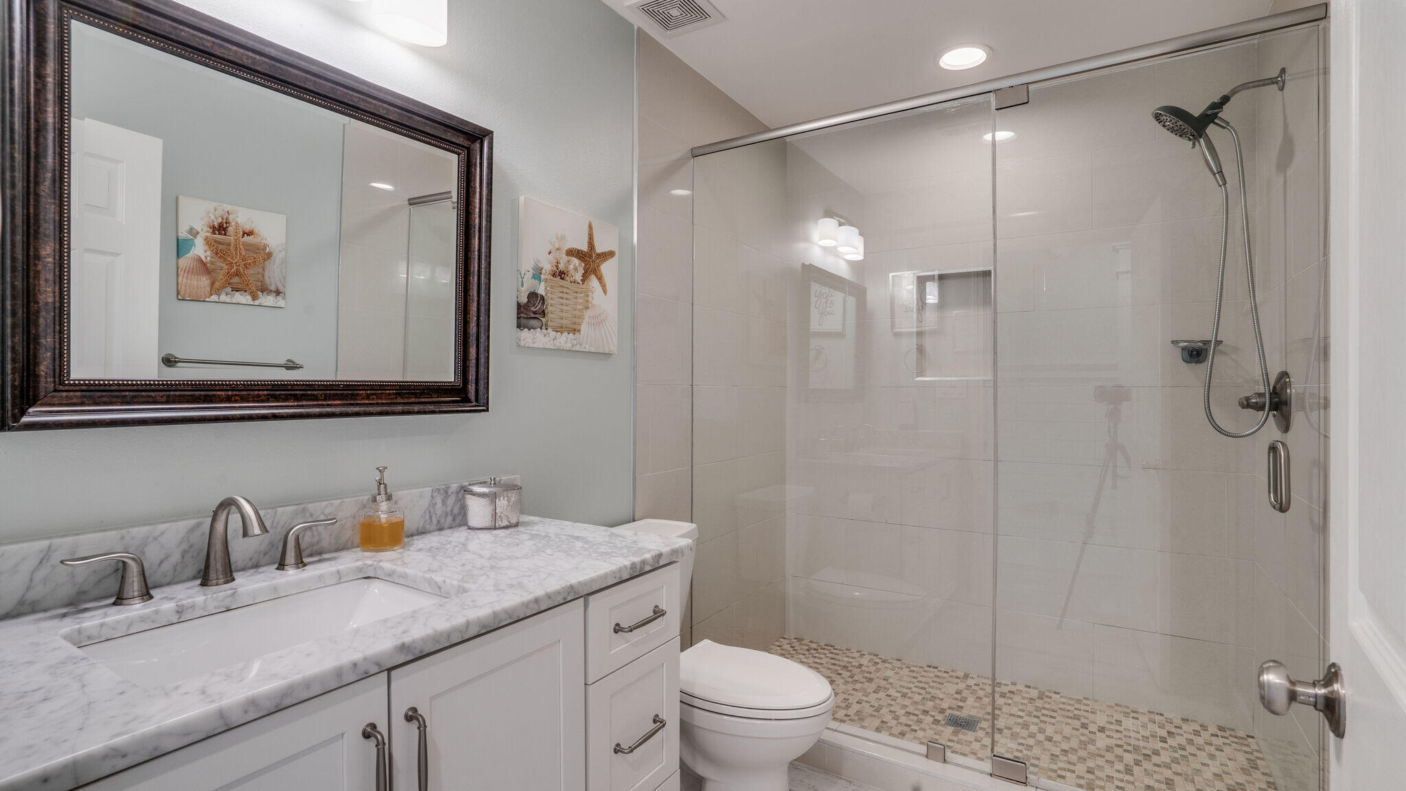 786 Mack Bayou Road Santa Rosa Beach, FL 32459 - Photo 28 of 42 a bathroom with a granite countertop sink a toilet a shower and a mirror