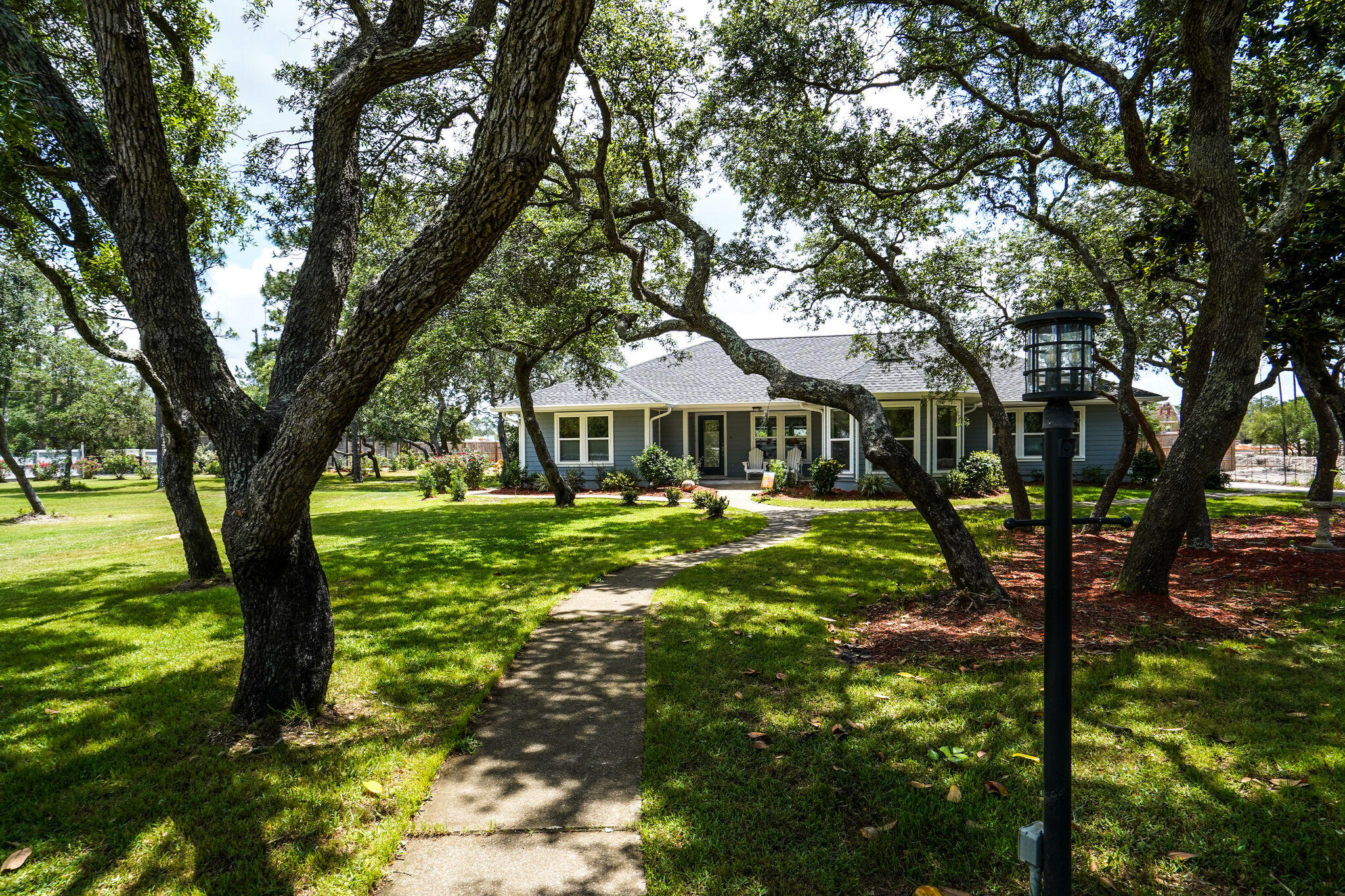 786 Mack Bayou Road Santa Rosa Beach, FL 32459 - Photo 40 of 42 a front view of a house with a yard