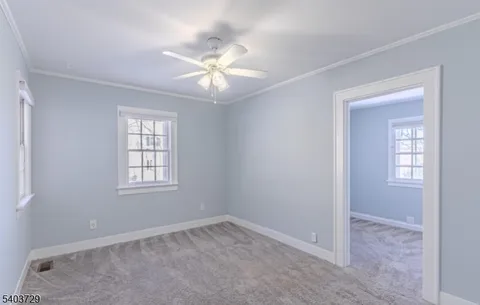 a view of a bedroom with a window and workspace