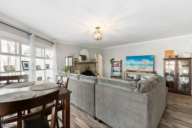 wooden floor fireplace and windows in an empty room