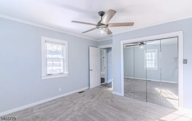 a view of a hallway with wooden floor and cabinet