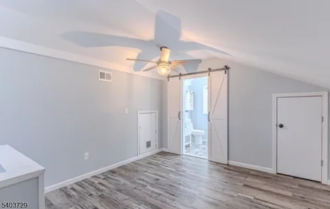 a large bed sitting in a bedroom and a chandelier