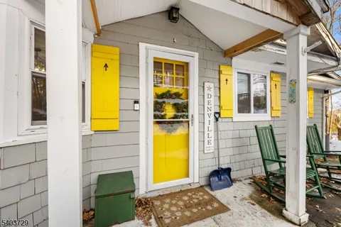 a kitchen with granite countertop a refrigerator stove top oven and sink