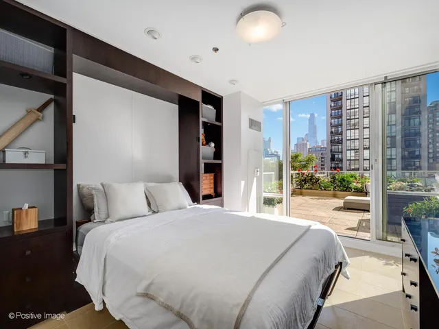 a bedroom with a large bed and a large window