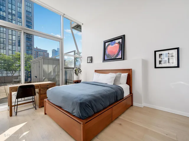 a bedroom with a bed and glass window