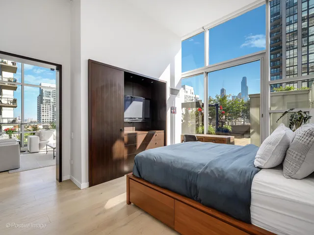 a bedroom with a large bed and a large window