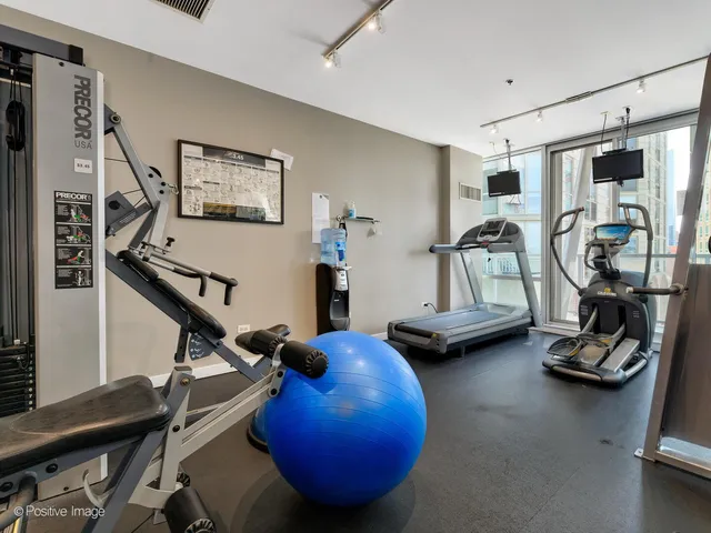 a room with gym equipment and a flat screen tv