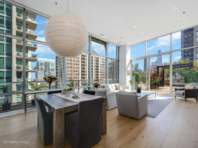 a dining hall with couches a flat tv screen and a dining table with garden view