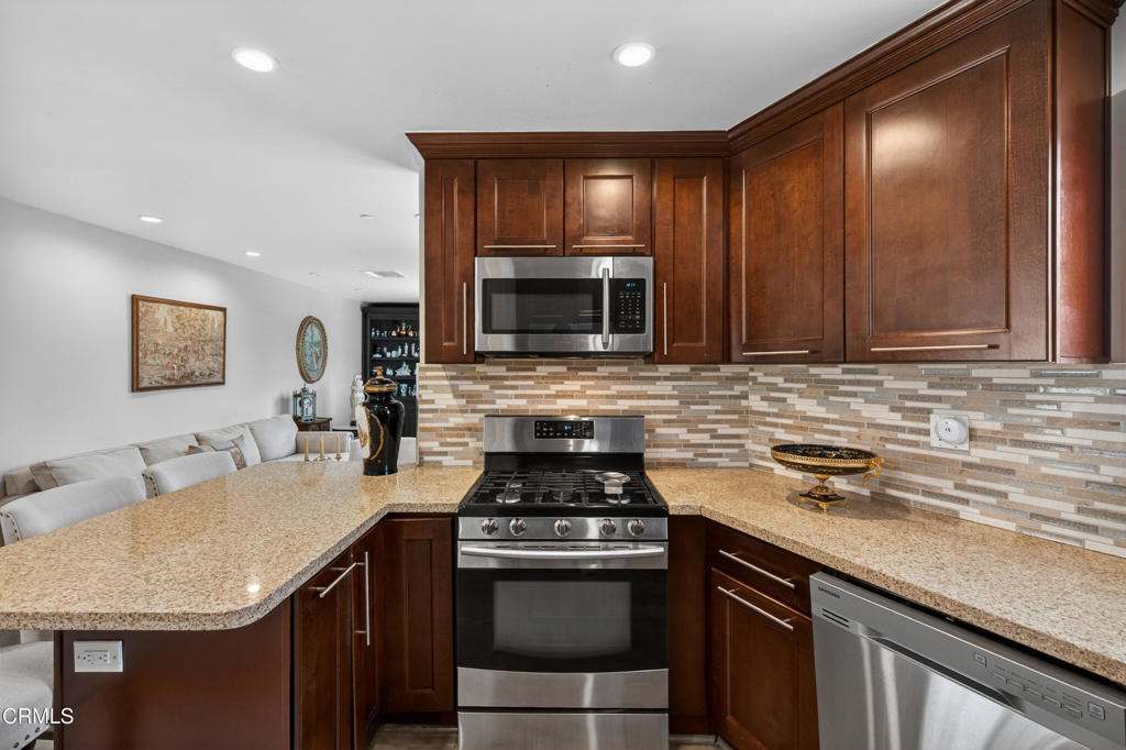 9325 La Shell Drive Tujunga, CA 91042 - Photo 35 of 46 a kitchen with kitchen island granite countertop a sink stainless steel appliances and cabinets