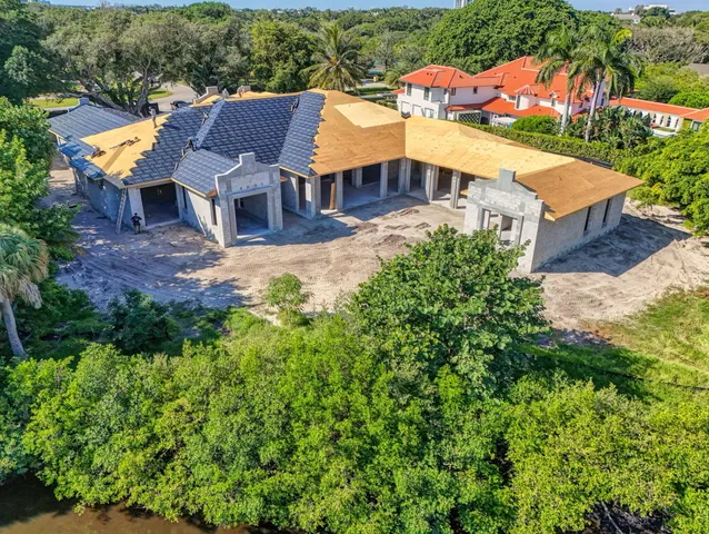 an aerial view of a house with swimming pool and garden